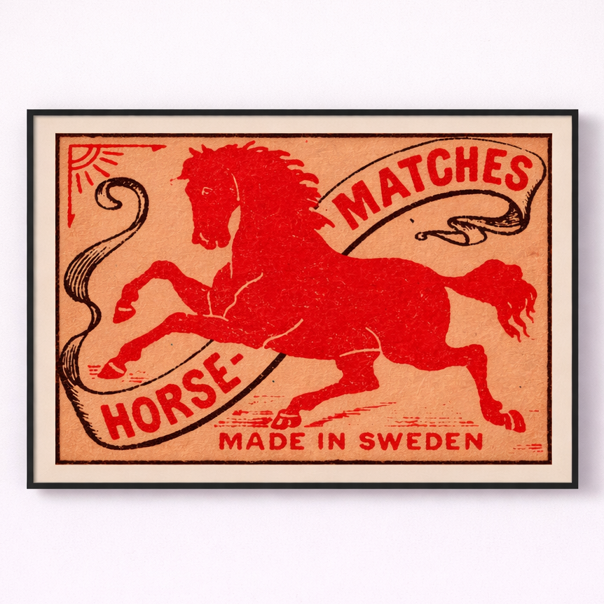 Framed matchbox label with a red horse design and text on a white background