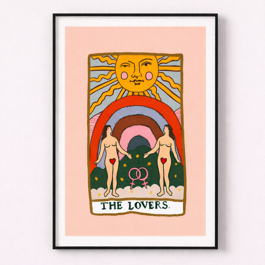 Framed artwork titled 'The Lovers' with a stylized illustration of two people, a rainbow, and a sun on a pink background.