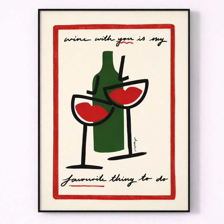 Framed artwork with a bottle and two glasses, text 'wine with you is my favourite thing to do', on a white background.