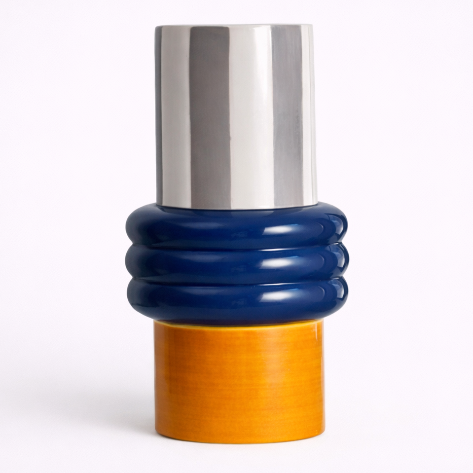 Multicolored cylindrical object with a silver top, blue middle section, and orange bottom on a white background