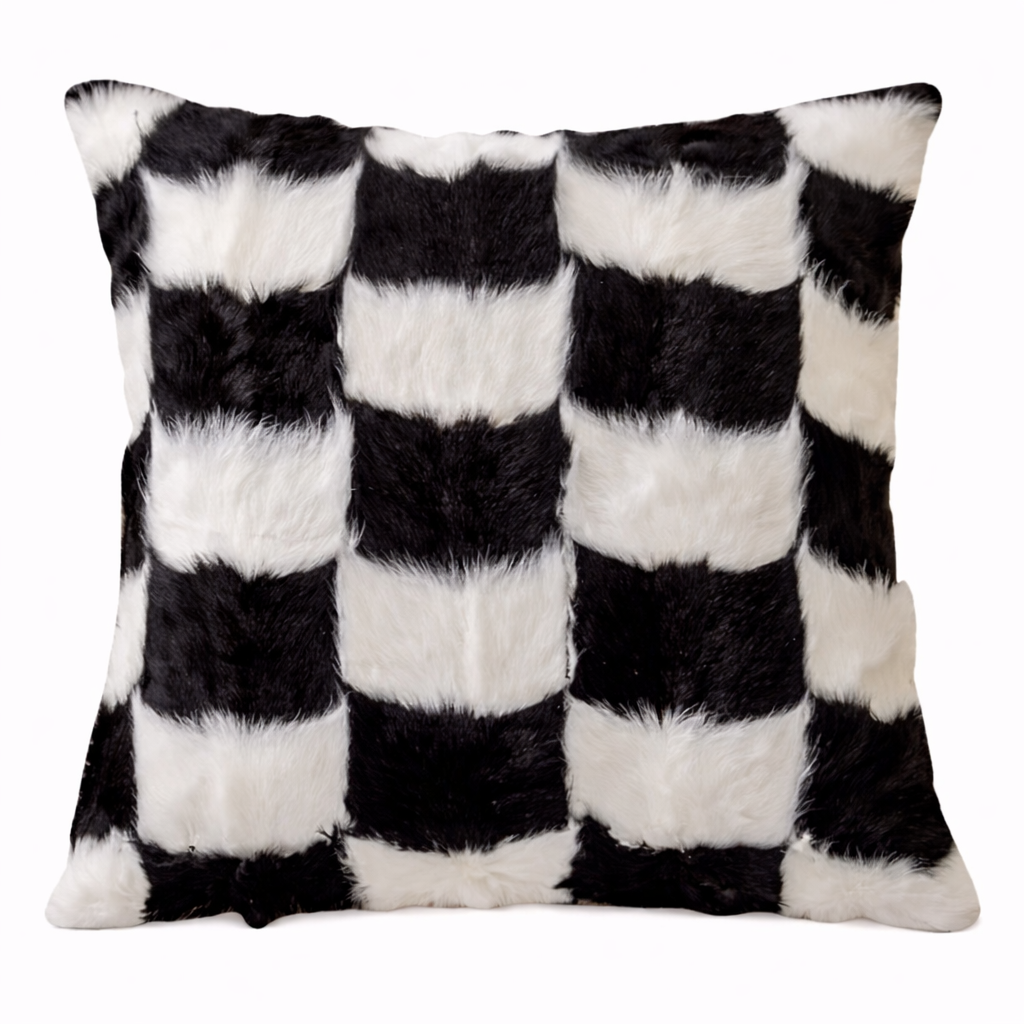 Checkered pillow with black and white fur pattern on a white background