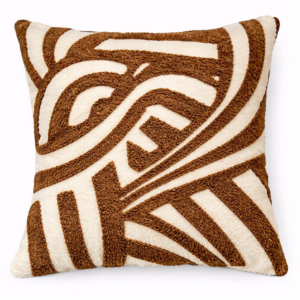 Decorative pillow with brown and white pattern on a white background