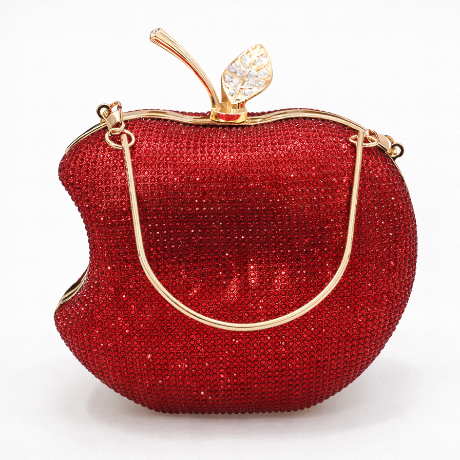 Red apple-shaped handbag with gold accents on a white background