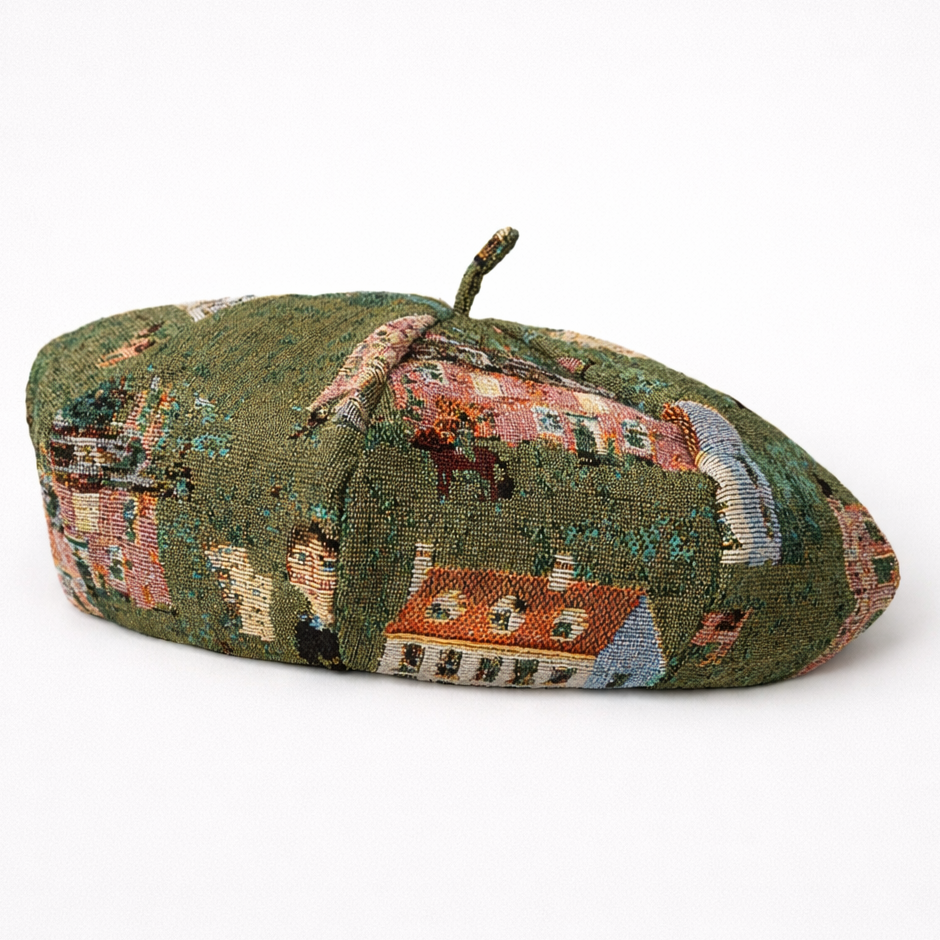 Green beret with embroidered scenes on a white background