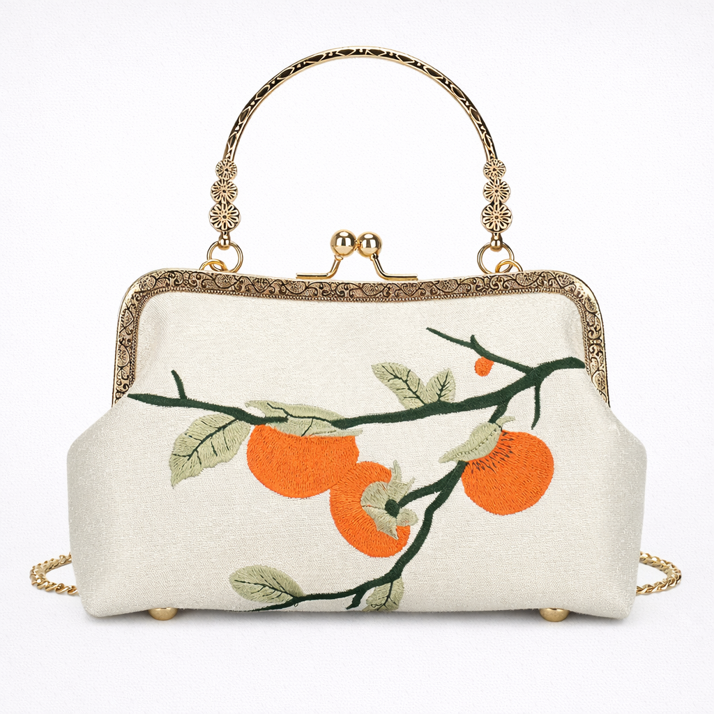 Handbag with orange and green branch design on a white background