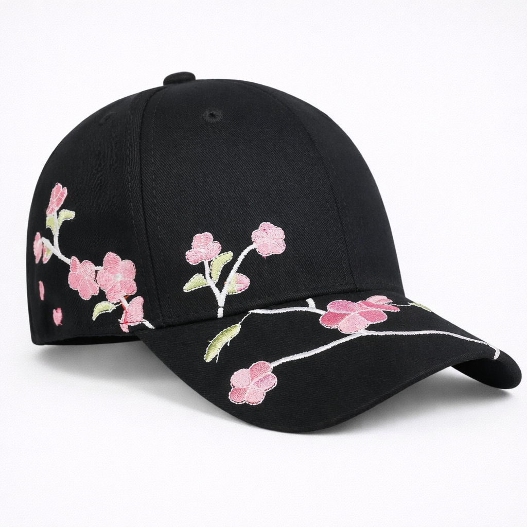 Black cap with pink floral embroidery on a white background