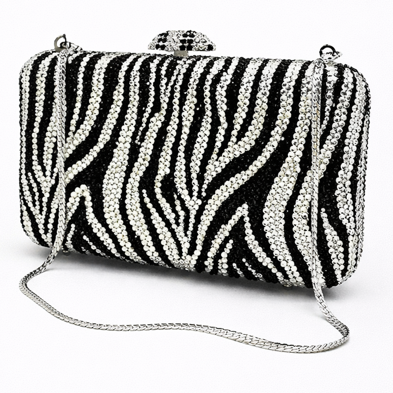 Zebra print clutch bag with a chain strap on a white background