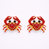 Pair of crab-shaped earrings with red hearts on a white background