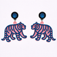 Tiger-shaped earrings with pink and blue design on a white background