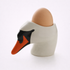 Ceramic swan-shaped egg holder with a brown egg on a white background