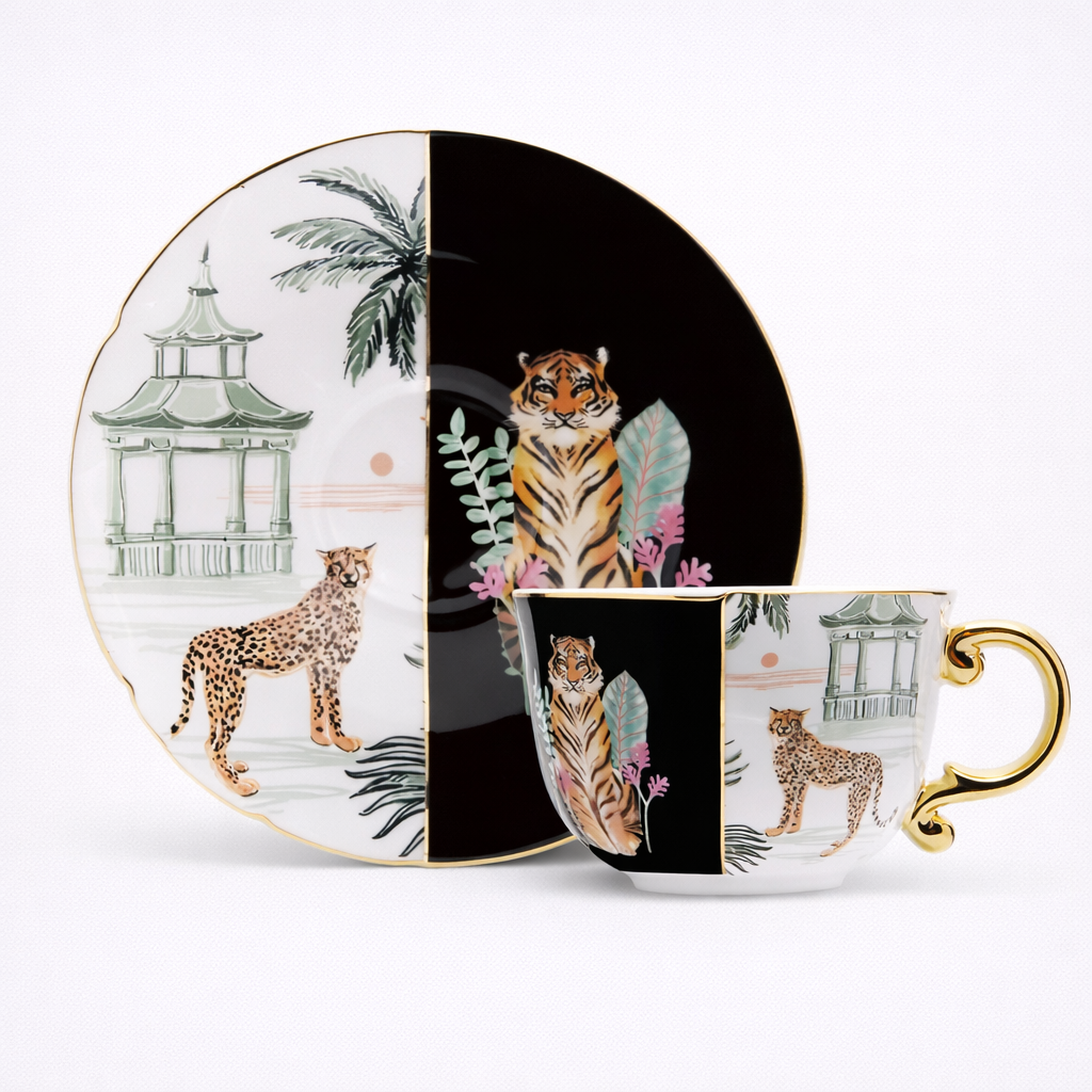 Teacup and saucer set with animal designs on a white background