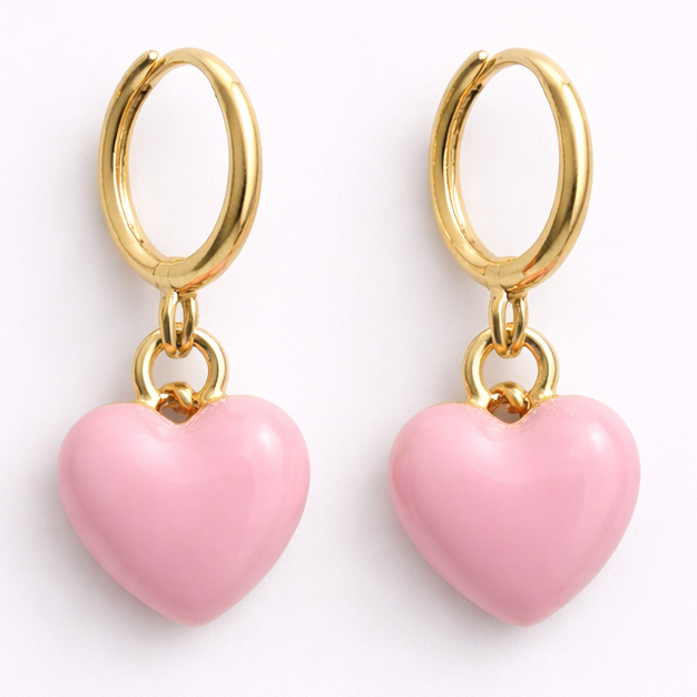 Gold hoop earrings with pink heart charms on a white background