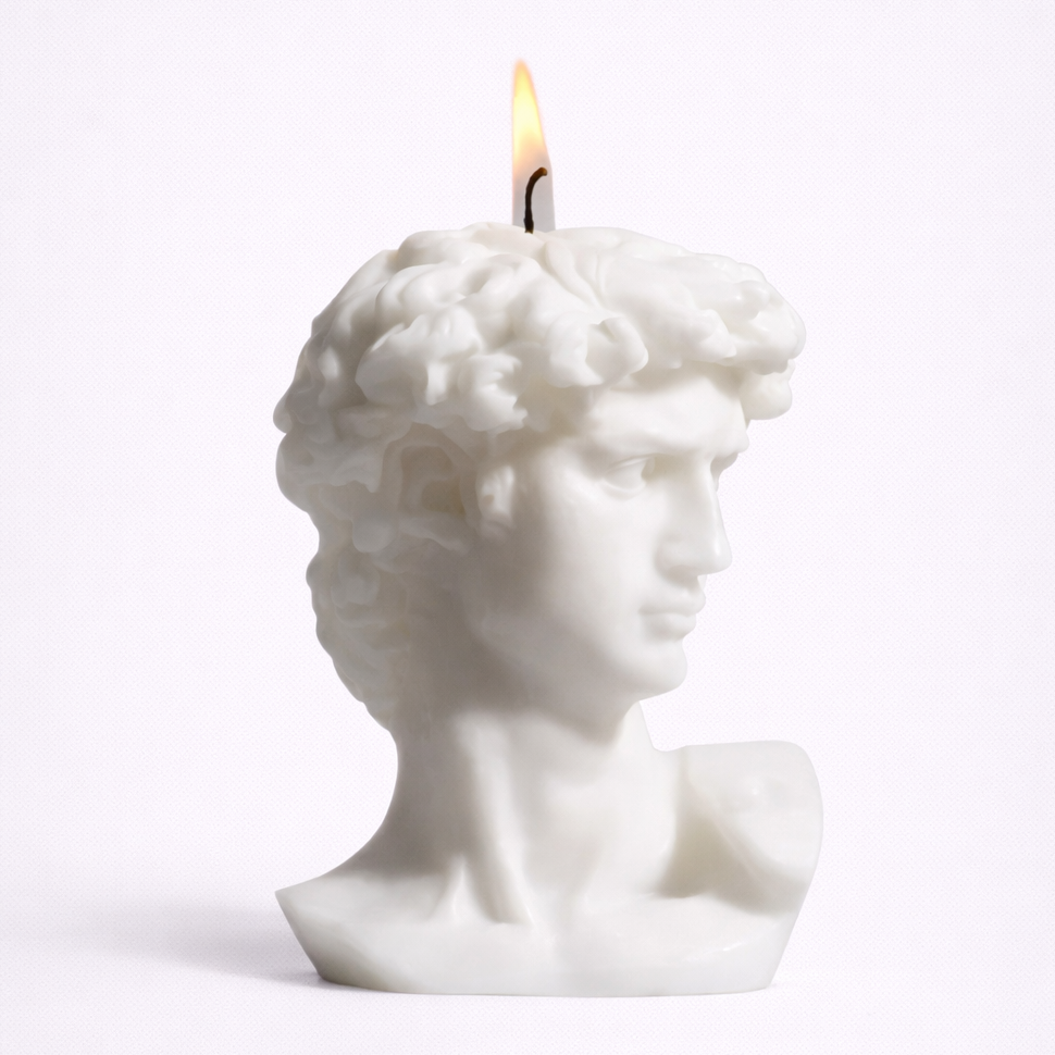 Candle shaped like a classical bust on a white background