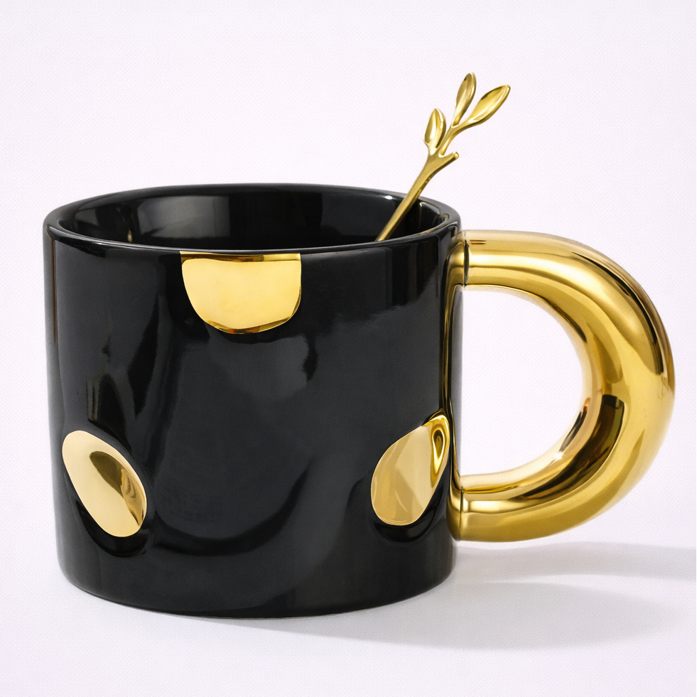 Black mug with gold accents on a white background