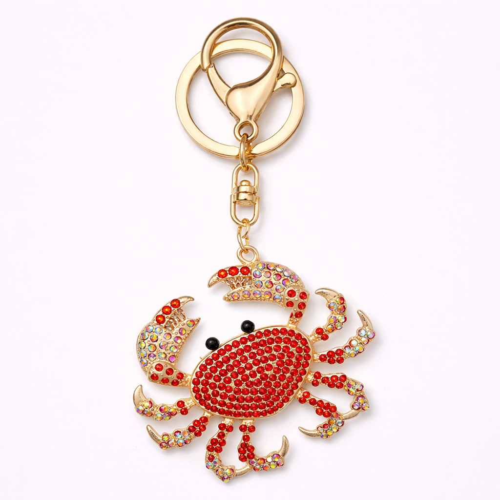 Crab-shaped keychain with rhinestones on a white background