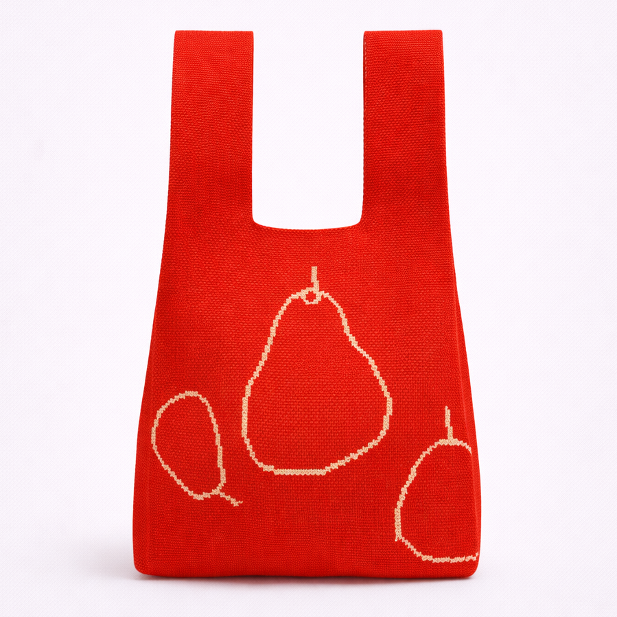 Red reusable shopping bag with pear designs on a white background