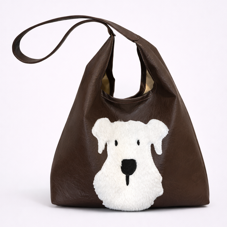 Brown bag with a white dog face design on a white background