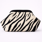 Clutch bag with zebra pattern on a white background