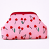 Small pink pouch with red floral pattern on a white background