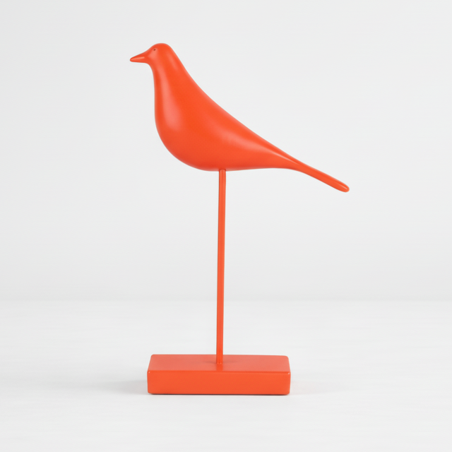 Orange bird-shaped object on a white background