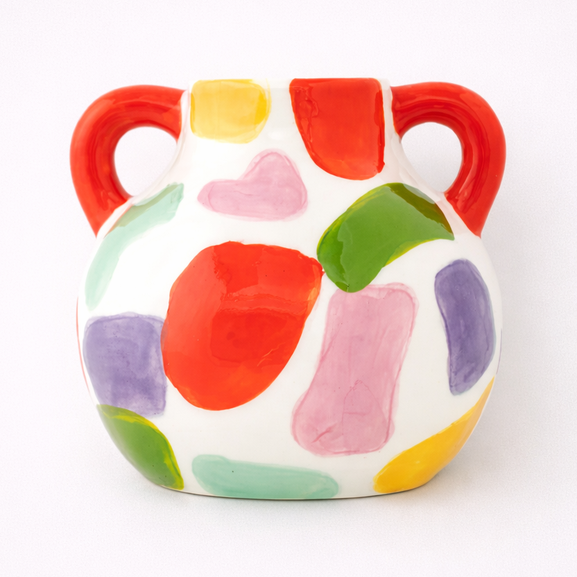 Colorful ceramic vase with measurements on a white background