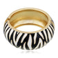 Gold ring with black and white zebra pattern on a white background