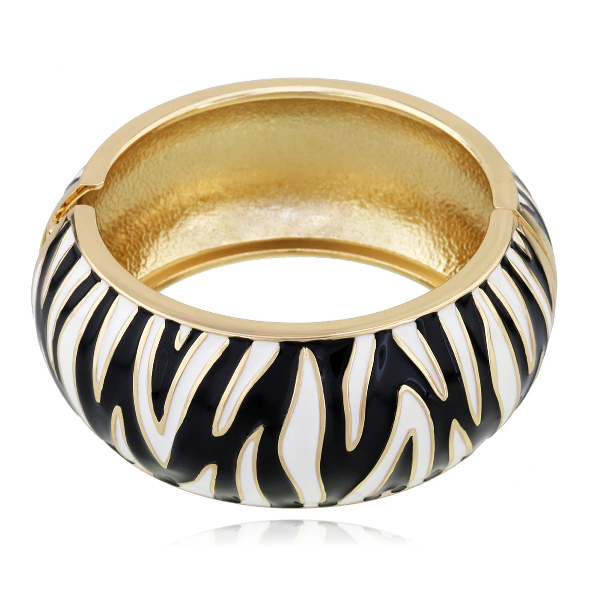 Gold ring with black and white zebra pattern on a white background