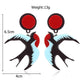 Pair of earrings with red and blue design, shown with measurements on a white background.