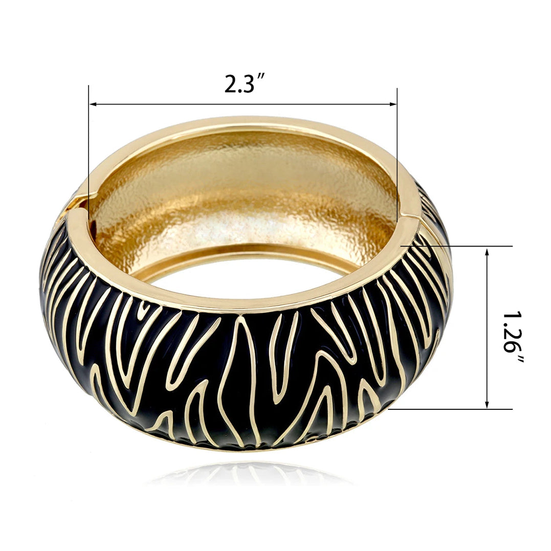 Gold bangle with black zebra stripe pattern and measurements on a white background