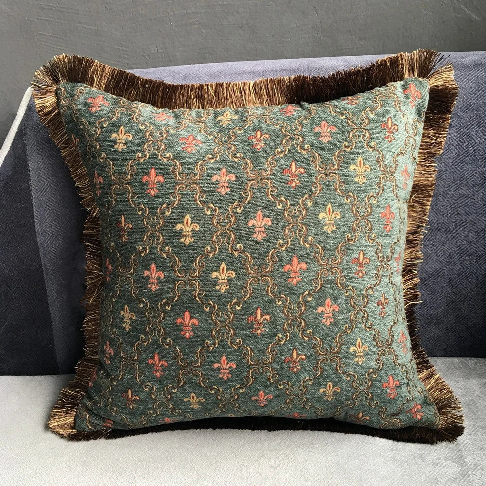 Decorative pillow with intricate pattern and fringes on a gray background