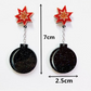 Star-shaped earrings with black round pendants, measurement details on a white background