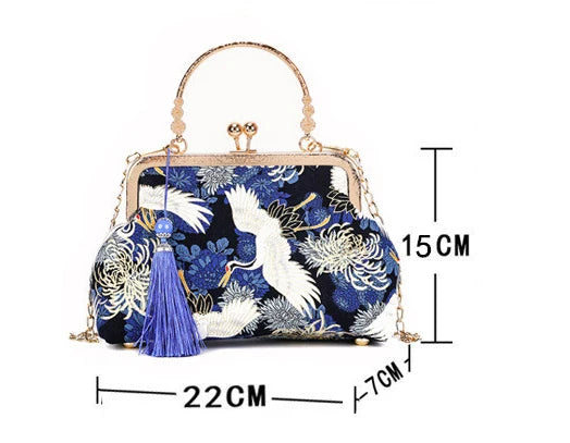 Blue floral handbag with tassel and measurements on a white background