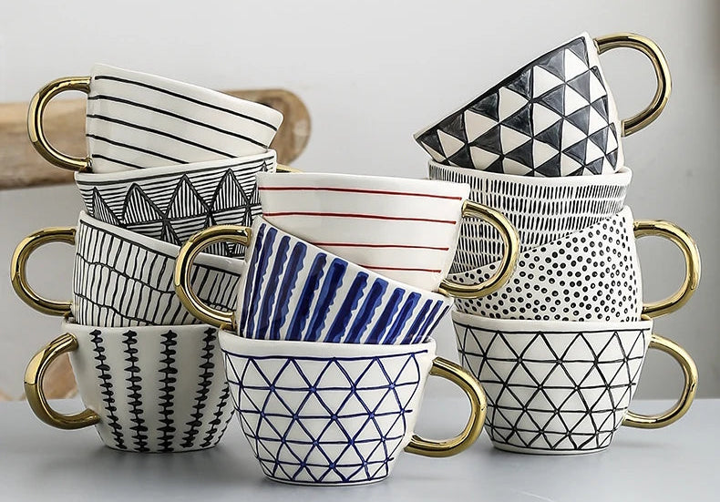 Set of ceramic mugs with geometric patterns on a light gray background