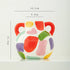 Colorful ceramic vase with measurements on a white background
