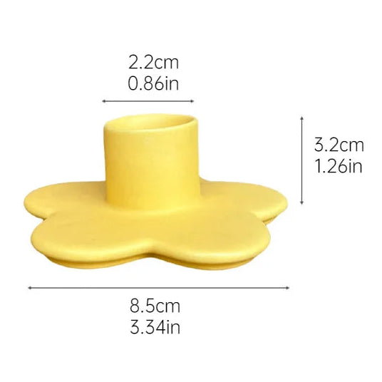 Yellow flower-shaped candle holder with dimensions on a white background
