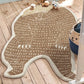 Bear-shaped rug on a wooden floor with toys around