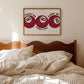 Bedroom with striped bedding and a framed artwork on the wall.