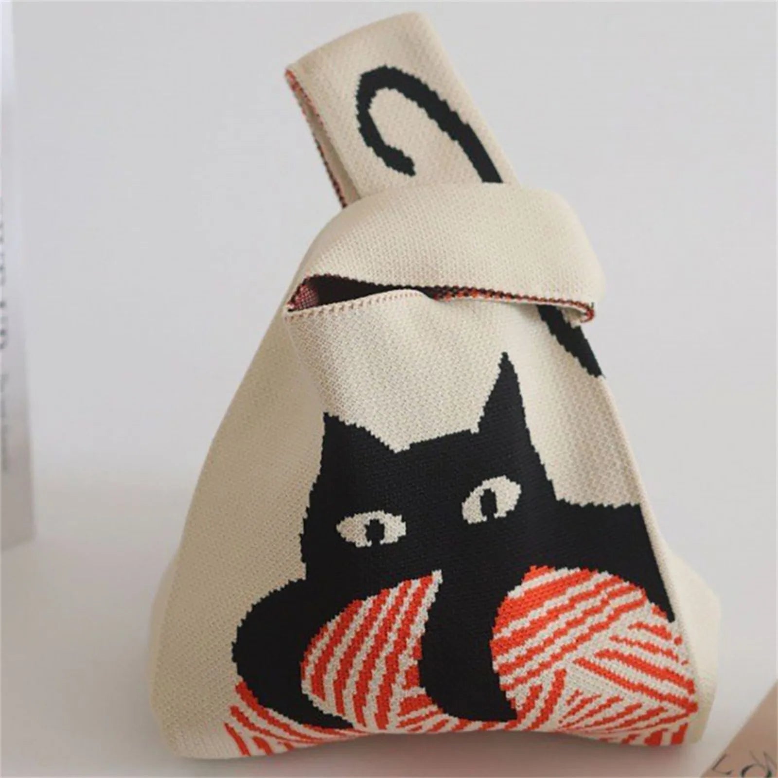 Canvas bag with a black cat and yarn design on a white background