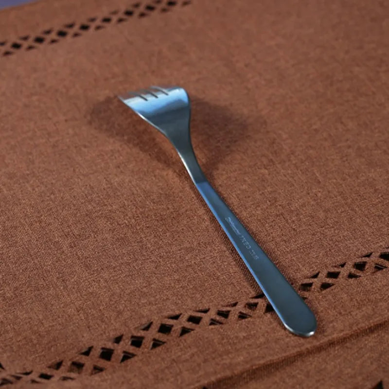Silver fork on a brown textured surface