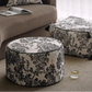 Round and square ottomans with floral pattern in a living room setting