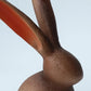 Close-up of a wooden rabbit figurine with a plain background