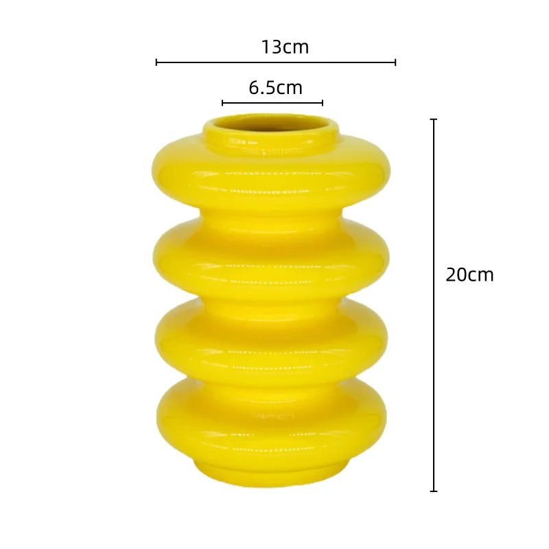 A yellow ceramic vase with geometric circle abstract overlays, measured dimensions shown as 13cm in diameter, 6.5cm in diameter at the neck, and 20cm in height.