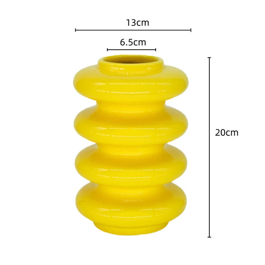 A yellow ceramic vase with geometric circle abstract overlays, measured dimensions shown as 13cm in diameter, 6.5cm in diameter at the neck, and 20cm in height.