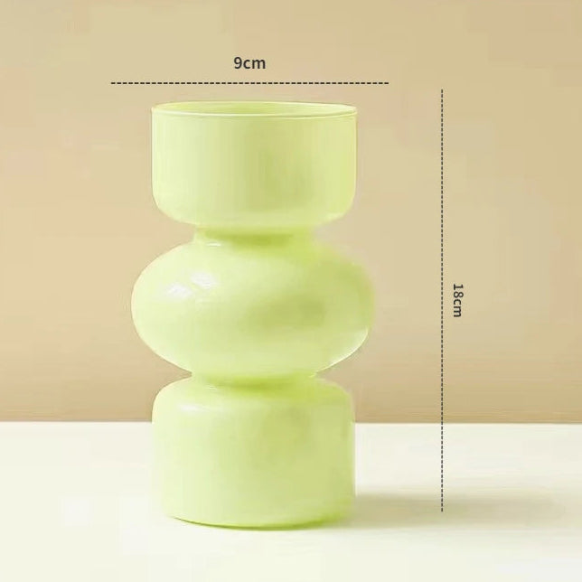 Green vase with measurements on a beige background