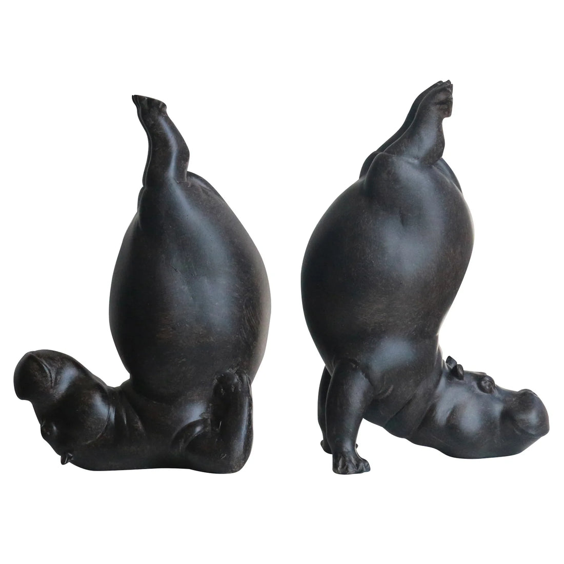 Two black hippo figurines on a white background
