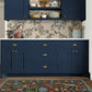 Navy blue kitchen cabinets with floral wallpaper and rug.
