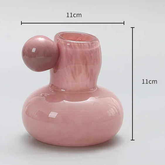 Pink ceramic vase with dimensions on a gray background