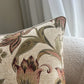 Floral patterned pillow on a neutral background
