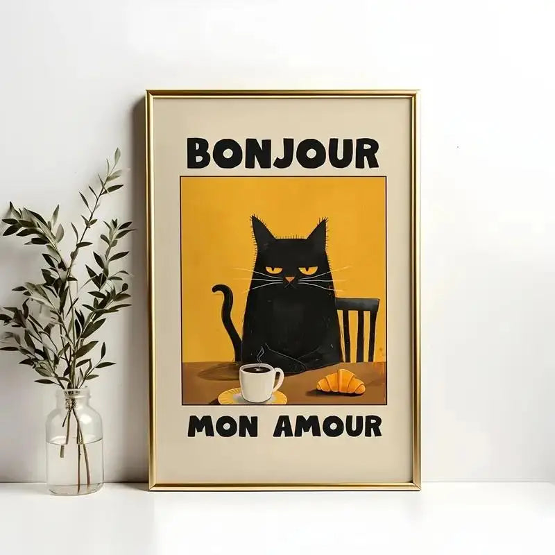 Framed artwork with a black cat, coffee cup, and croissant on a yellow background with 'Bonjour Mon Amour' text.