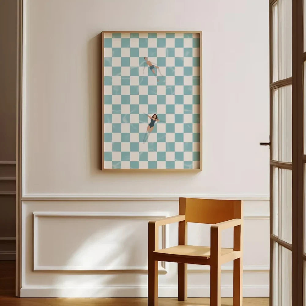 Framed checkered artwork on a wall with a wooden chair below